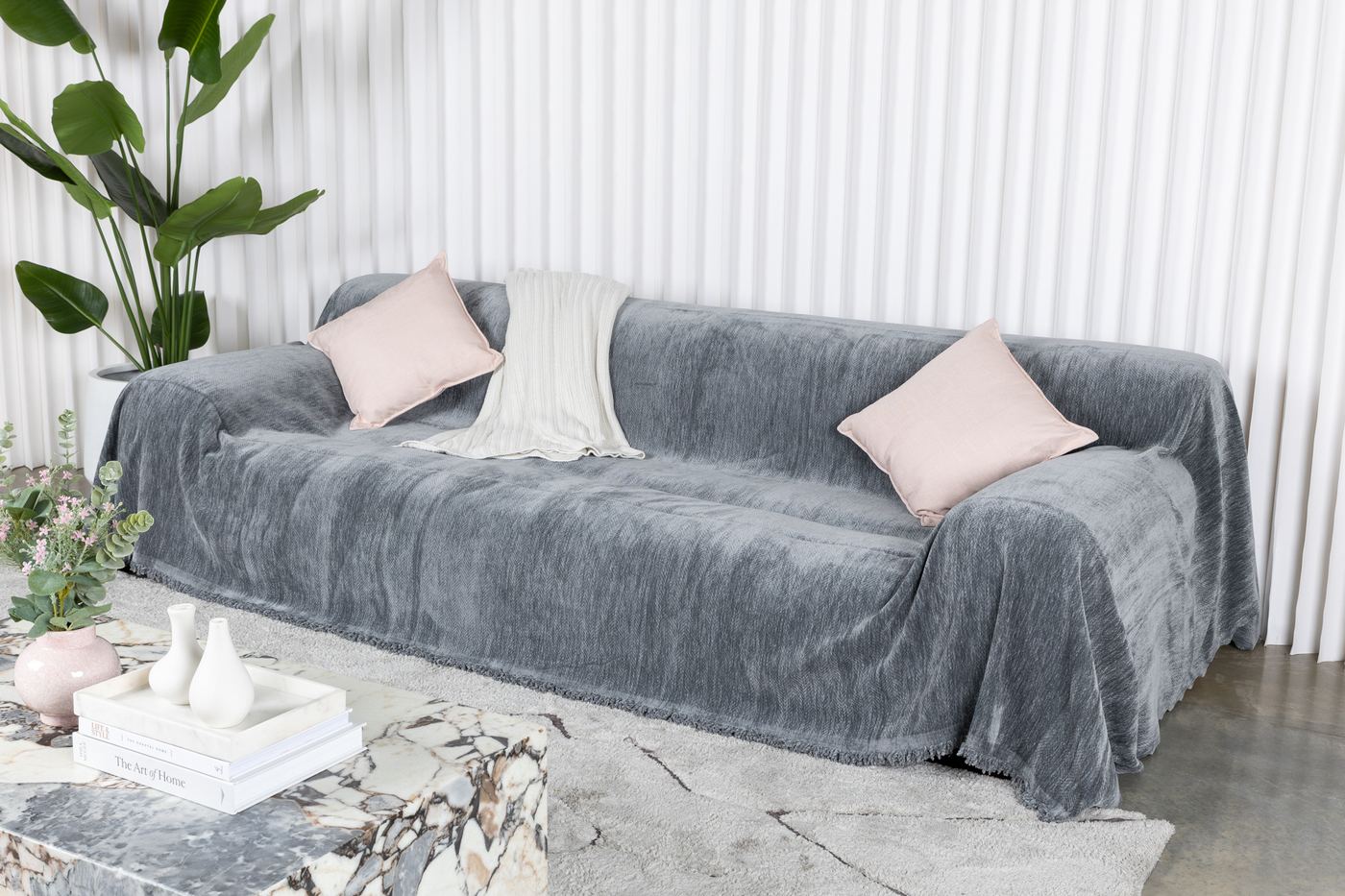 Slate gray CouchCare Pro Protector draped over a full three-seat sofa.